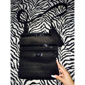 Over the shoulder black Micheal Kors bag.