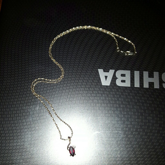Gold chain with garnet charm