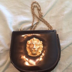 black leather purse with gold lion