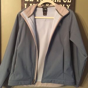 North Face. Light bluish gray jacket with hood.
