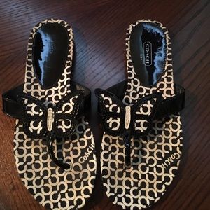 Black and white Coach butterfly flip flops.