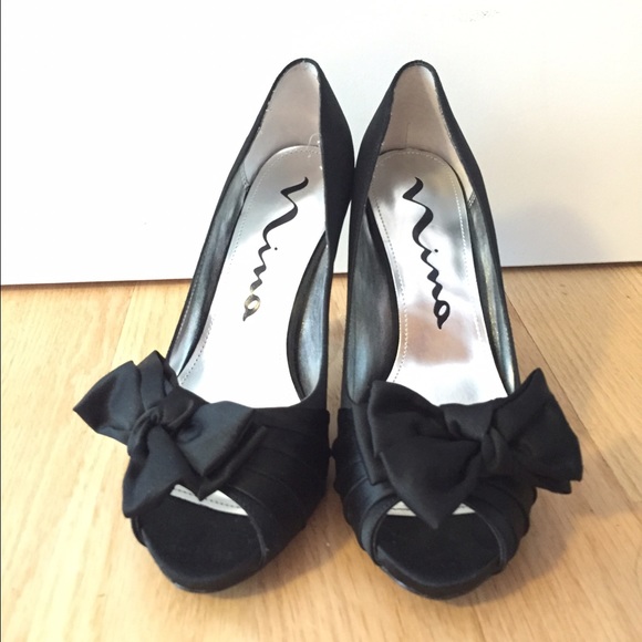 Black satin peep toe heels. Bow detail.