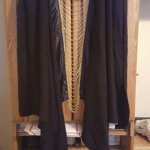 Cardigan black with gold chains in the back.