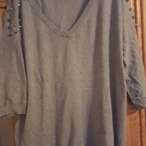 Gray sweater with spikes.