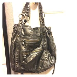 Hand bag or purse that goes over one shoulder.