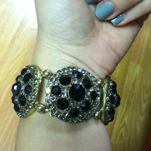 Gold bangle with black and gray rhinestones