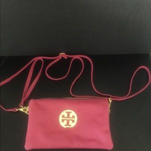 Hot pink crossbody handbag with wristlet strap