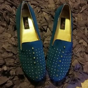 Royal blue suede studded flats.