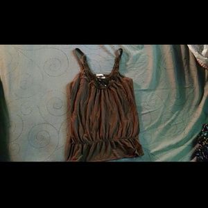 Flowy tank top with lace embellishments.