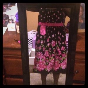 Black dress with pink flowers and green leaves