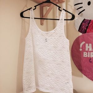 White sleeveless top w/ tribal inspired pattern