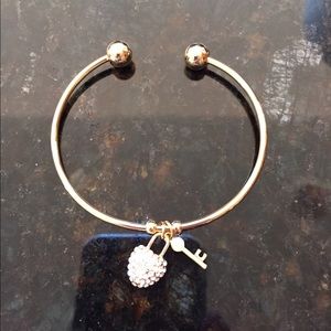 Gold bangle bracelet with charms