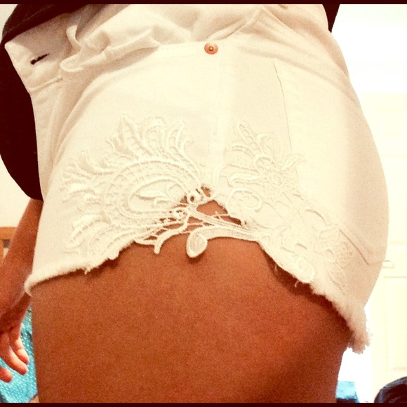White high rise shorts with lace side patterns.