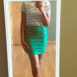 Green Rampage mini skirt with gold button detail