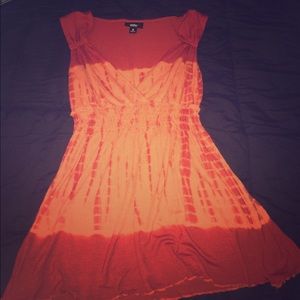 Somewhat of an orange v-neck tie-dye shirt.