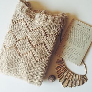 Tan sweater with see through details.