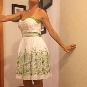 Strapless white dress with green embroidery
