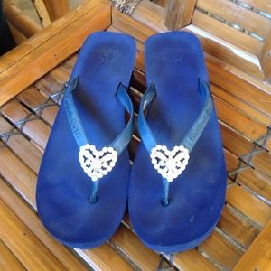 Navy blue twisted heart wedge flip flops