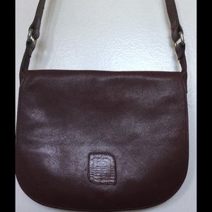 Small oxblood cross body leather purse.