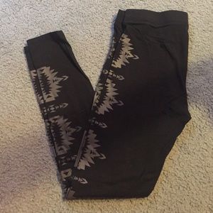 Black legging with gray tribal print down each leg