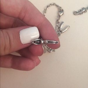Retired silver swimmer/diver charm