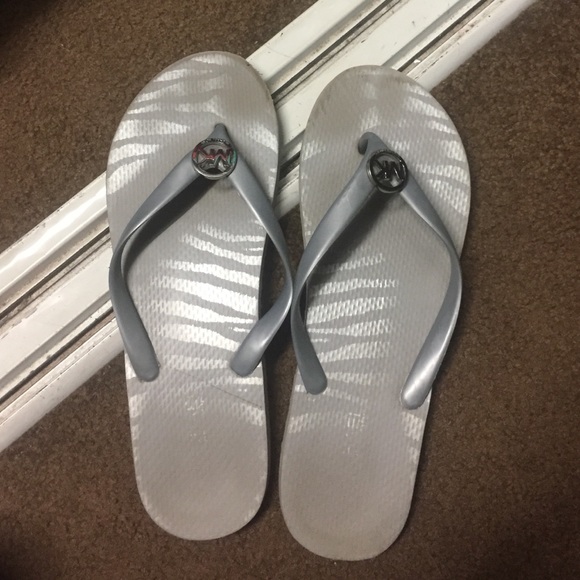 Michael Kora flip flops in silver.