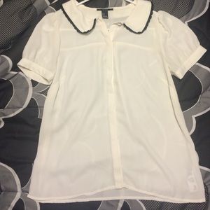White shirt with black lace trimming on collar.
