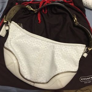 Coach handbag, white with metallic gold accents.