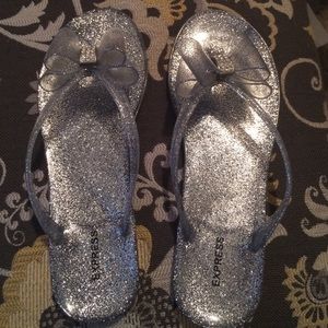 Express sparkly silver bow flip flops