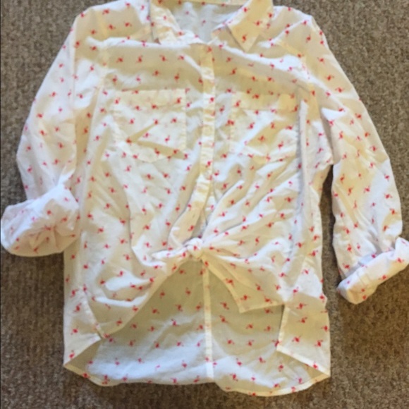 Collared white shirt with pink flamingos.