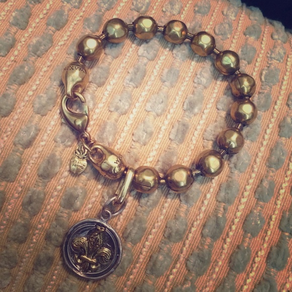 Waxing poetic bracelet with fleur de lis charm