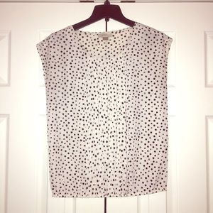 Cream blouse with black and gray polka dots.
