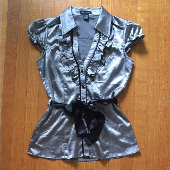 Shiny silver button-up blouse.
