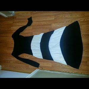 Long sleeved long black and white dress.