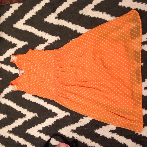 Orange with white polka dot dress.