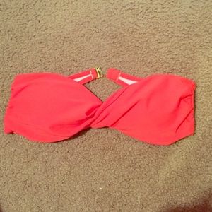Coral strapless bathing suit top.