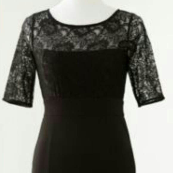 Black knee length dress with lace at the top.