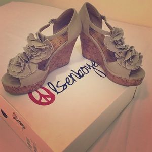 Olsenboye tan wedges with flower accents.