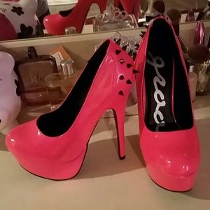 Neon pink spiked heels