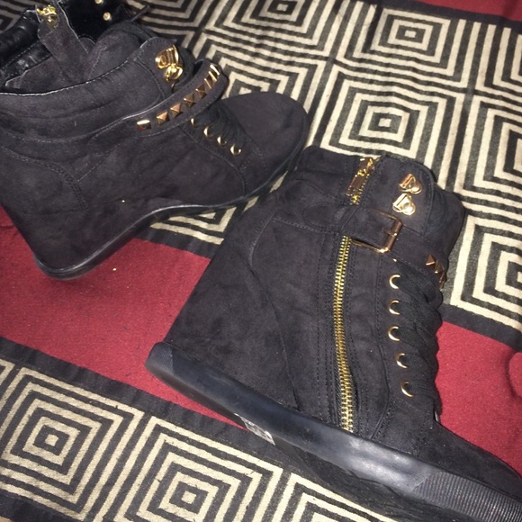 Sneaker wedge with gold zipper & straps in front.