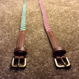 One pink redish white belt and one green blue belt