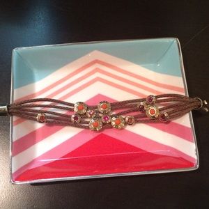 Brown Henri bendel bracelet with moveable charms