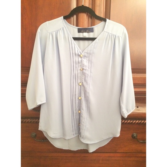 Small powder blue blouse with gold buttons