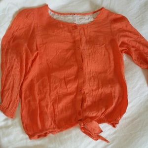 Orange top with white lace flower detail on back