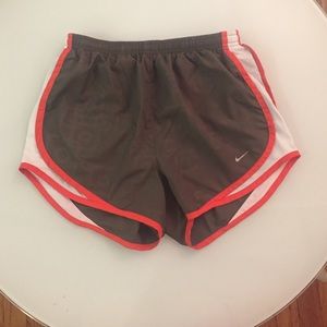 Gray and orange Nike running shorts