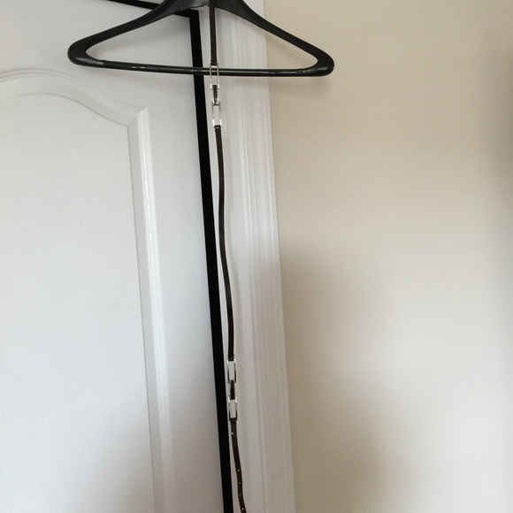 SOLD. Brown skinny belt with metal detail