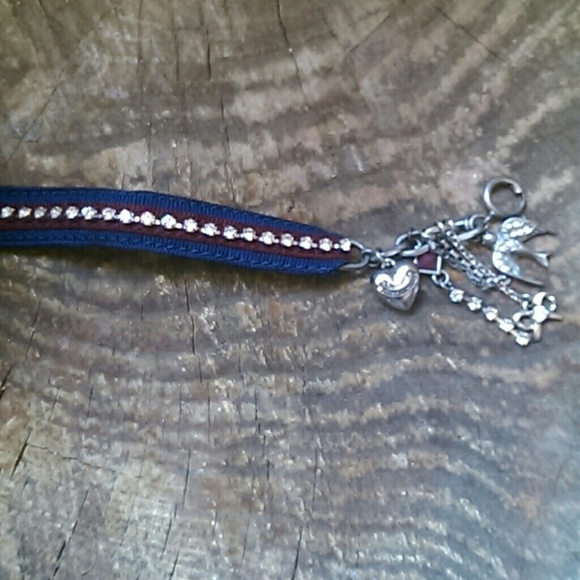 Red bejeweled and blue charm bracelet with bag