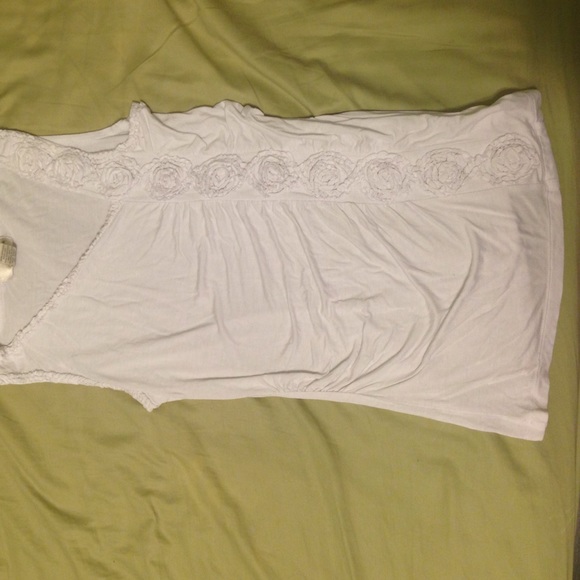 White sleeveless top with ruched rose side