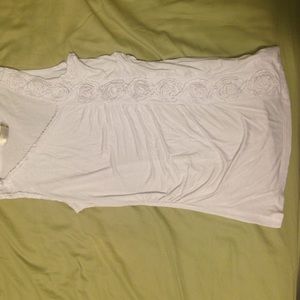 White sleeveless top with ruched rose side