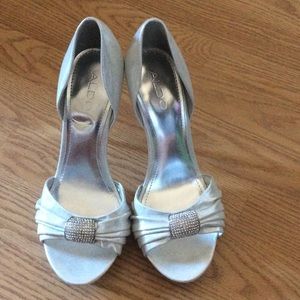 Silver heels with rhinestone detail on front